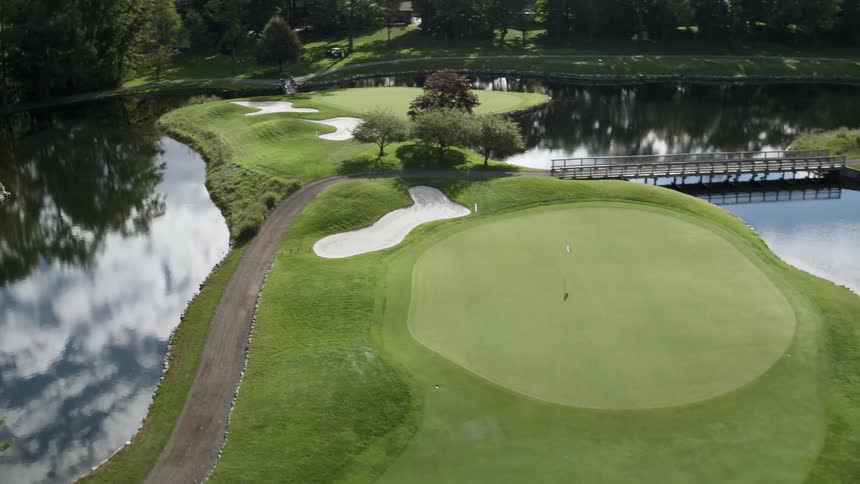 People are playing golf on the golf course