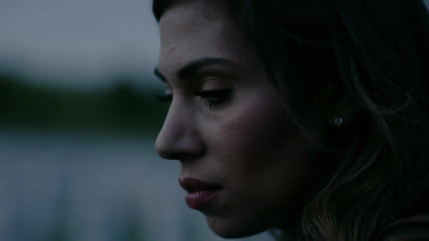 A woman stares down outside