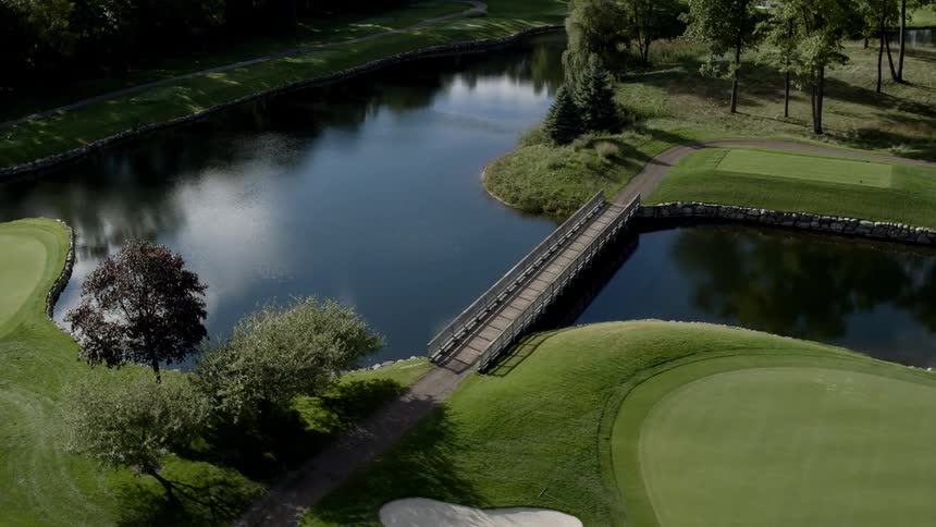 A bridge traverses a hole on a golf course