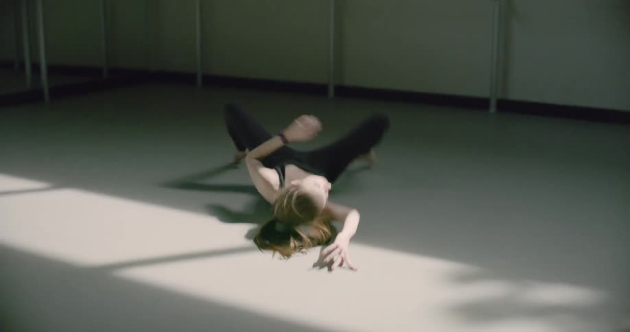 A woman is doing an intense dance routine