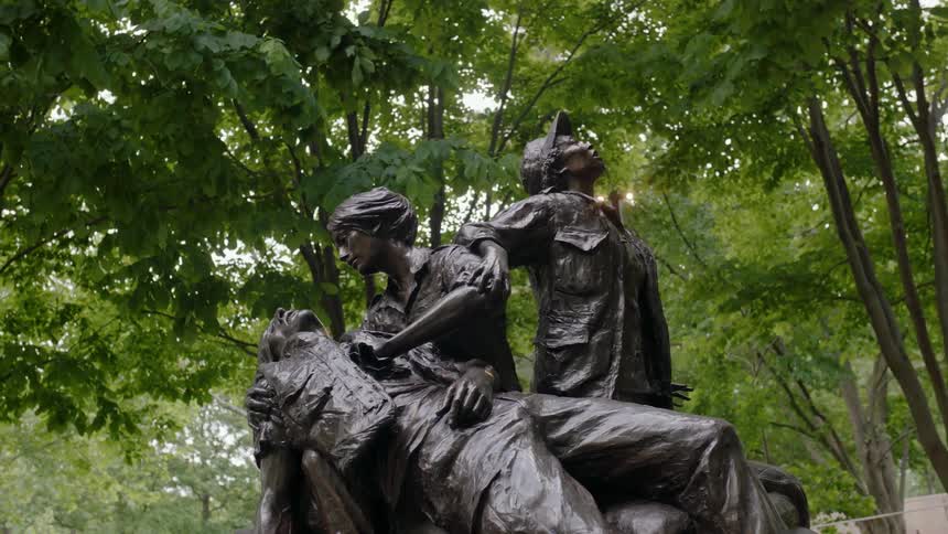 Statue standing in an area surrounded by trees