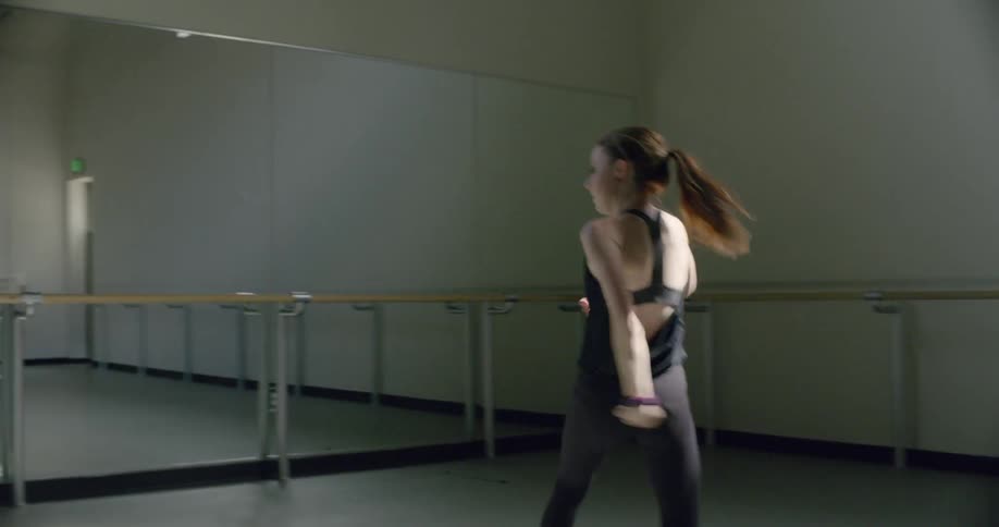 A woman is dancing in a dance studio