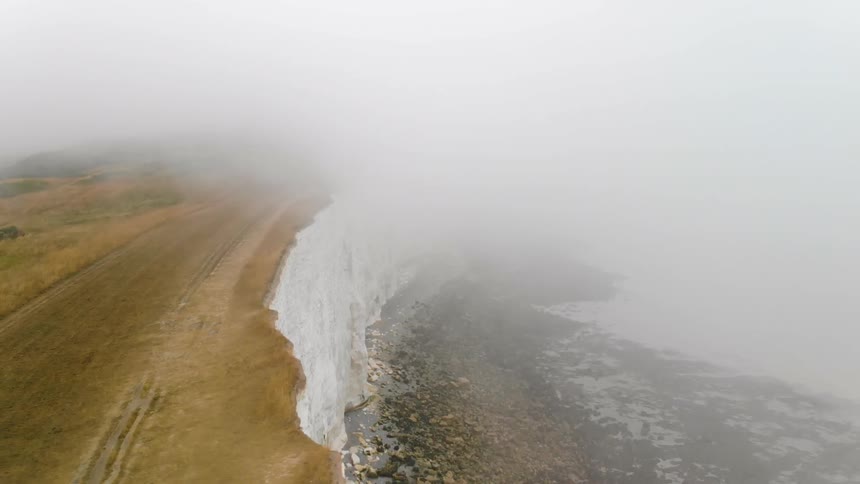 A fog covered cliff edge