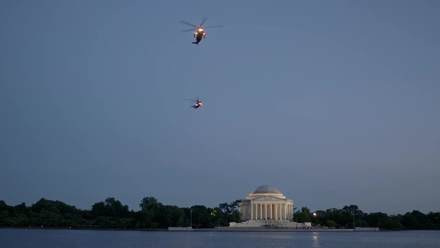 Two helicopters are flying over the state capital