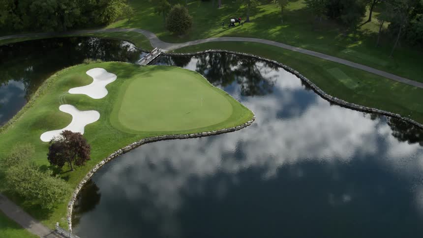The golf course has bridges going over the water