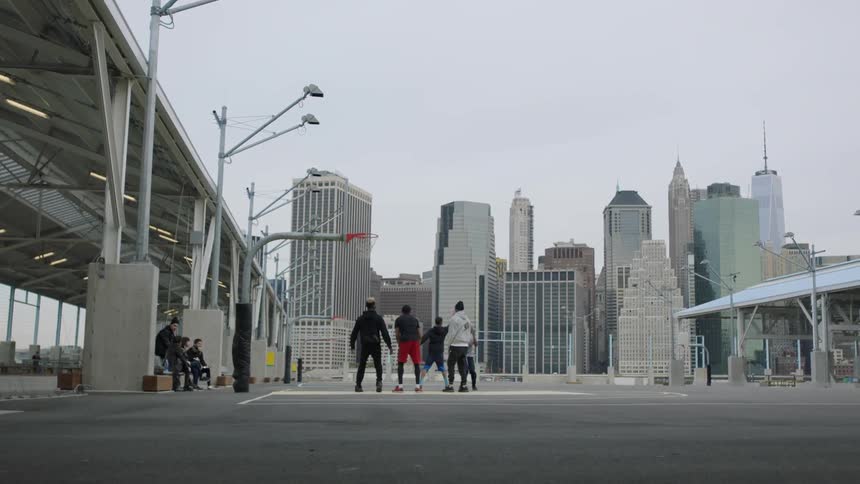 People playing outdoor basketball downtown