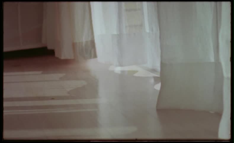 Curtains blowing in the wind in a room 
