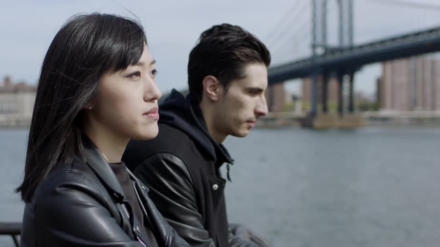 A man and woman look out over the harbor