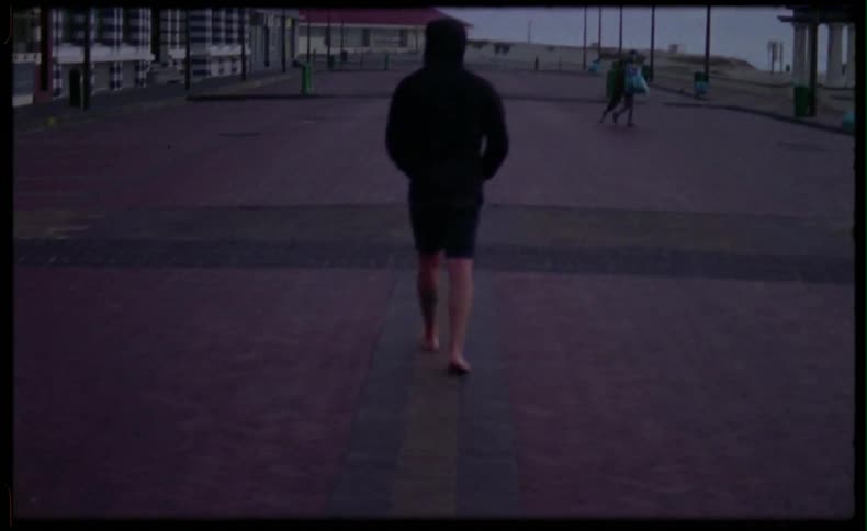 People are walking along the boardwalk