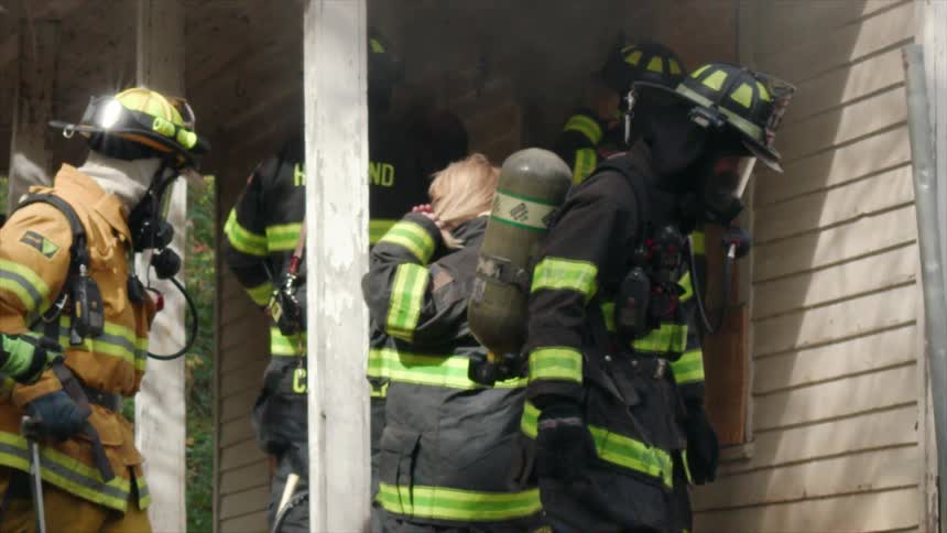 Firemen are making entry to a burning house