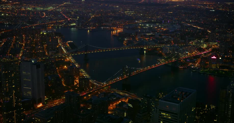 City lit up at night with bridges crossing over water