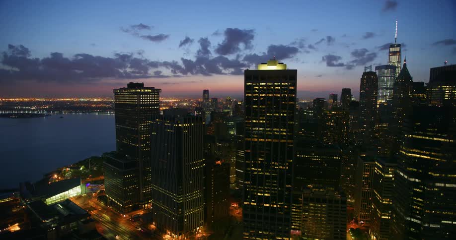Aerial view of a large city at sunset next to water