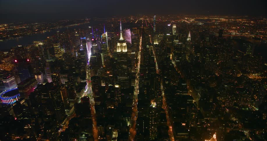 City buildings and street lights illuminate the city at night