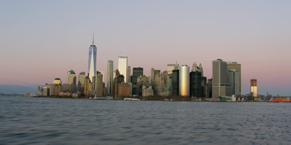 Tall city buildings tower over the water