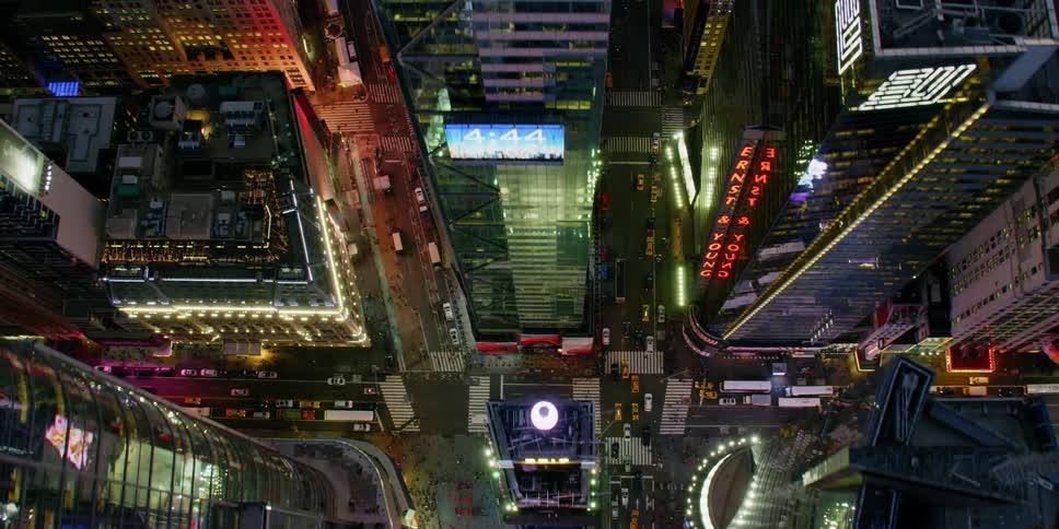 Electronic billboards and signs flash on city skyscrapers at night