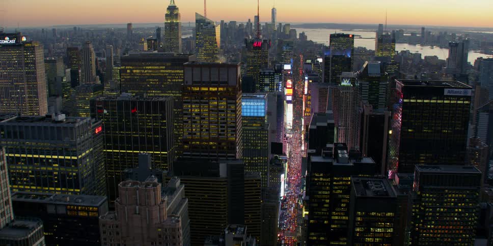 Tall city buildings tower into the sky over the city street