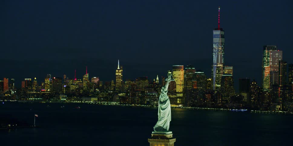 A helicopter flies above the statue of liberty