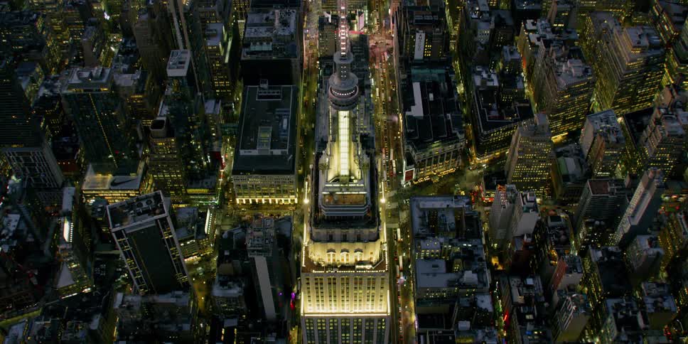 The city buildings illuminate the night sky