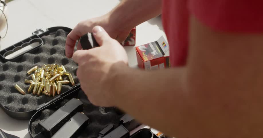 Person loading ammunition into a firearm clip