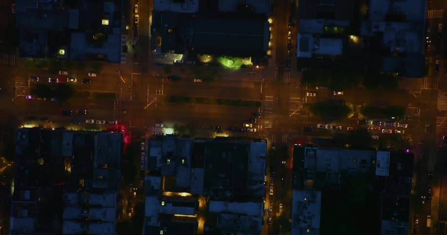 Cars travel on city streets at night