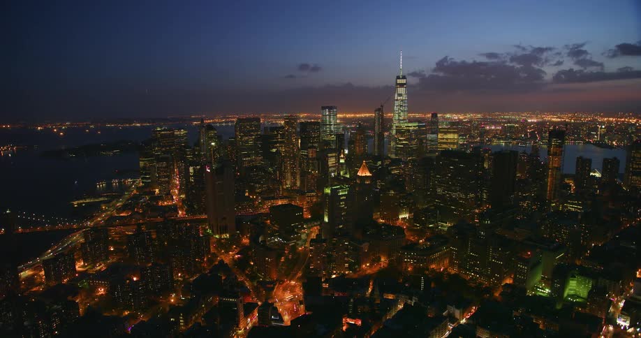 Tall city buildings illuminate the night sky