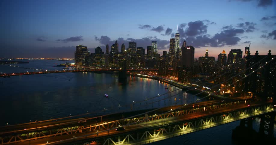 The brooklyn bridge is flown over at night