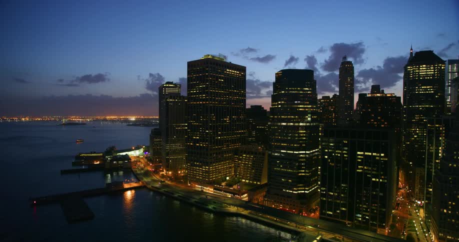 Aerial view of a large city at sunset next to water