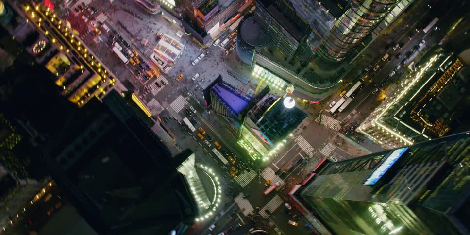 Tall city buildings illuminate the night sky