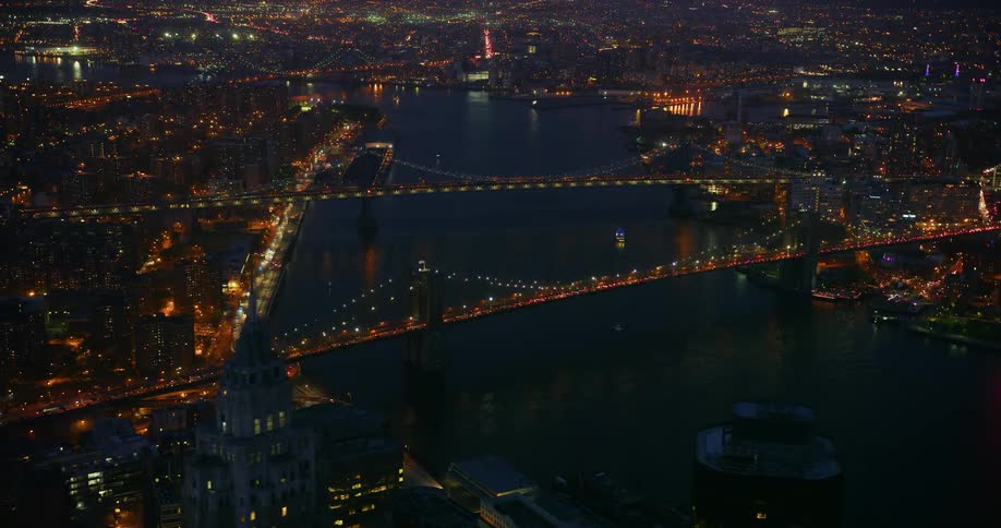 Vehicles travel on a bridge at night