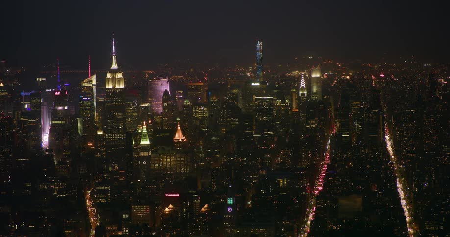 Traffic travels on the new york streets at night