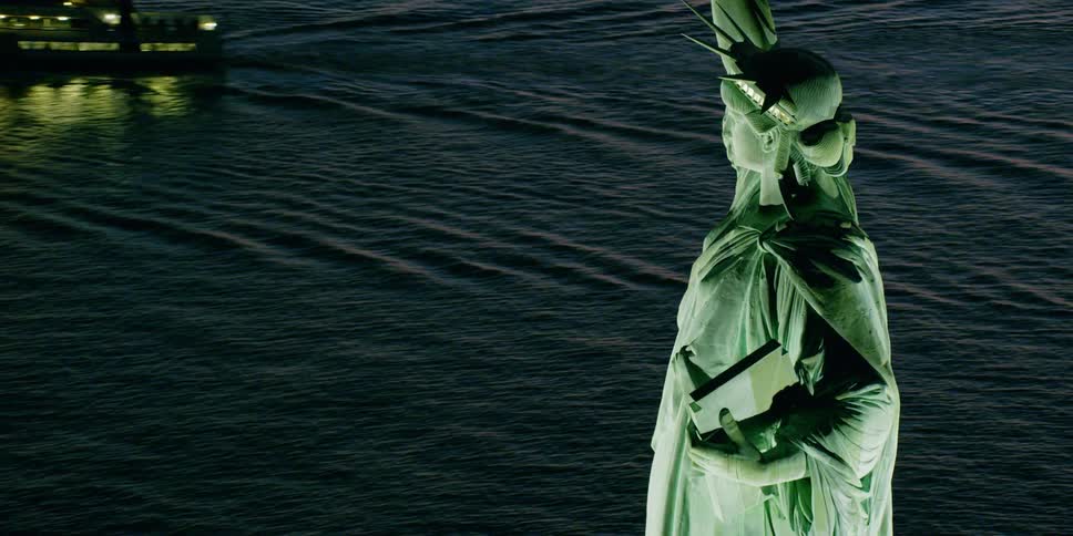 The statue of liberty stands tall in the water