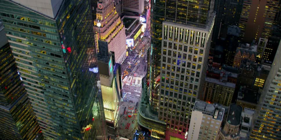 Skyscrapers and digital billboards shine in a city at night