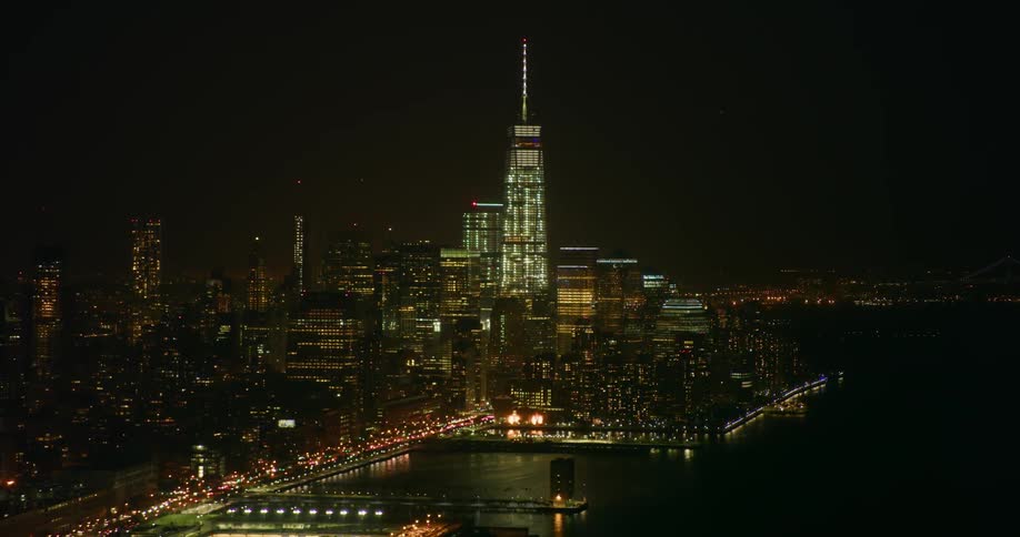 Tall city towers illuminate the night