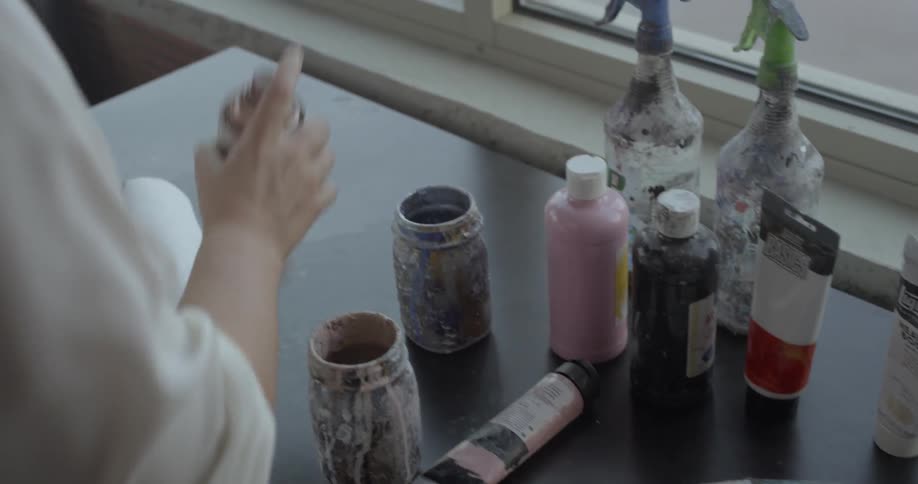 Woman grabs a paper towel and sprays rustoleum onto it