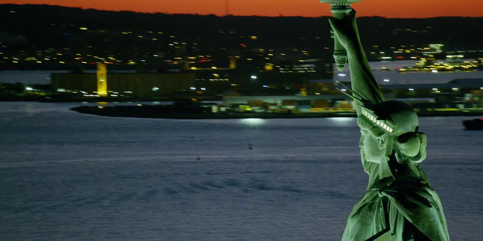 Aerial view of the area around the statue of liberty at sunset