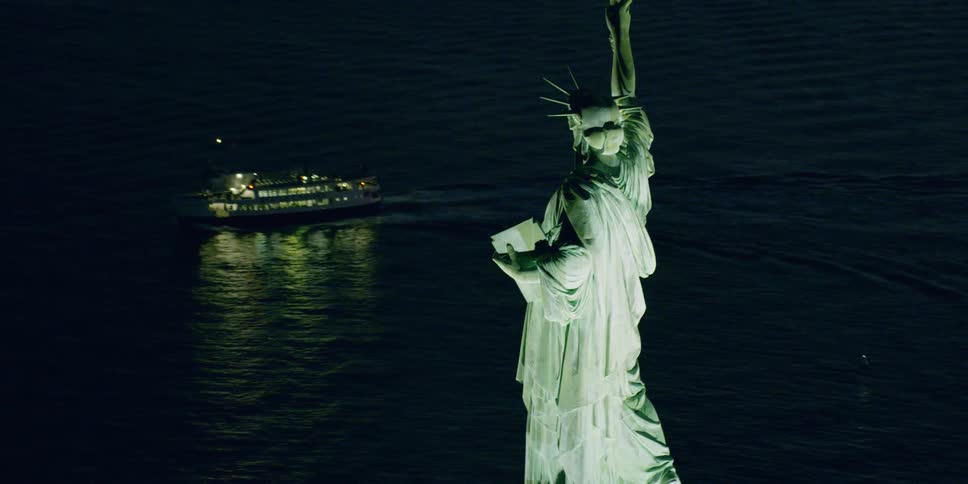 A ferry cruises past the statue of liberty