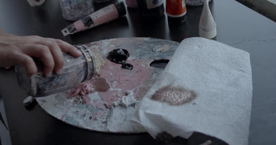 An artist mixes paint together