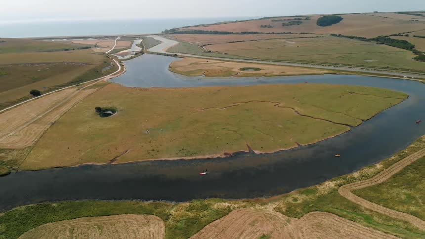 A river cuts through a grassy plain