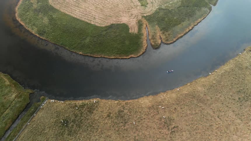A boat travels on a river