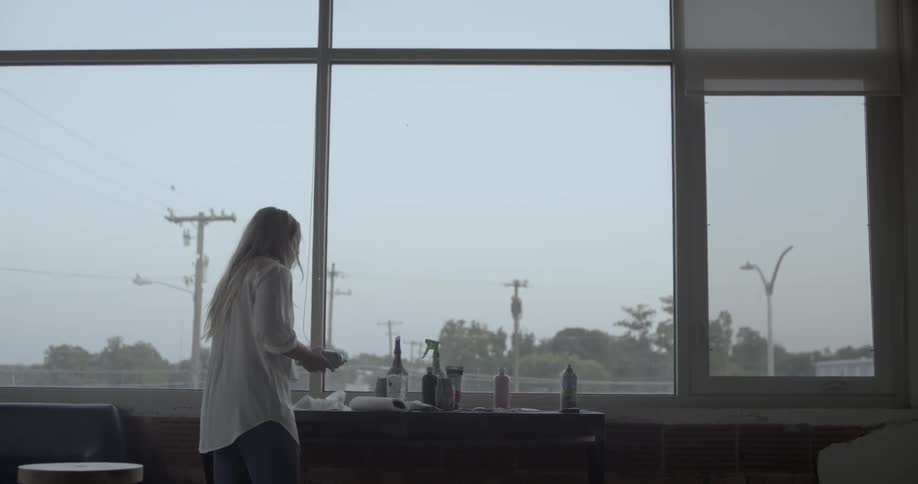 A woman walks towards an artist space in a studio