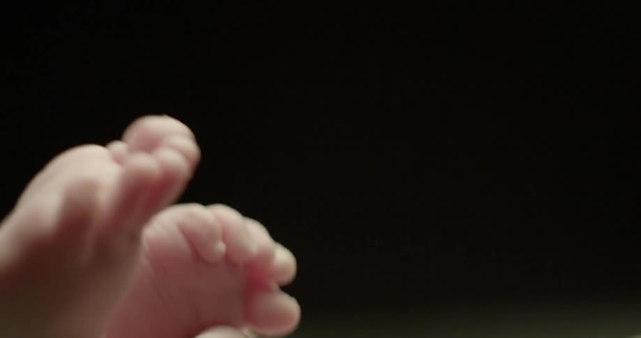 A baby wiggles and grabs its foot