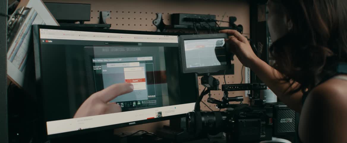 A woman adjusts video equipment
