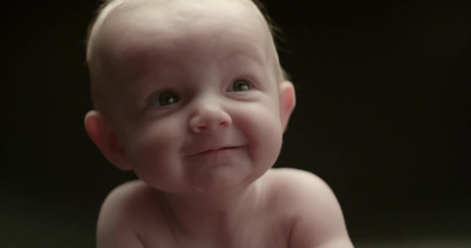 A baby smiles and laughs