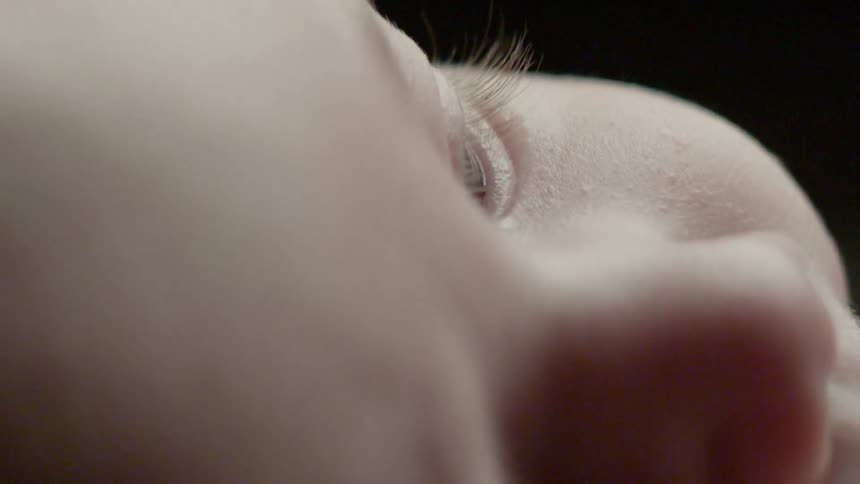An infant is looking at something intently