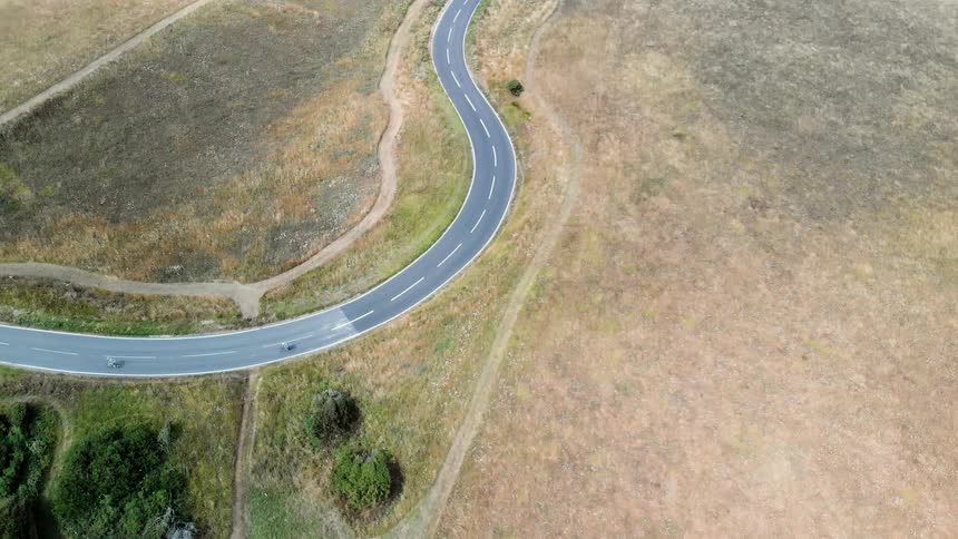 Vehicles drive on a curvy road