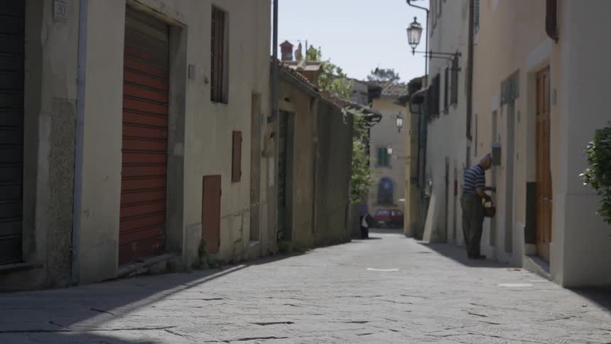Narrow street running between rows of buildings