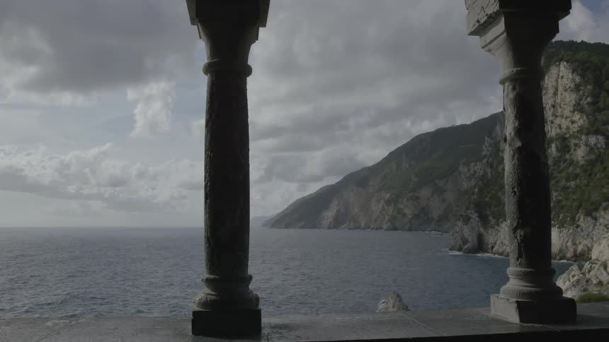 Looking through the open arched windows to sea below