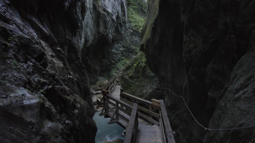 A wooden path leads down into a narrow gorge