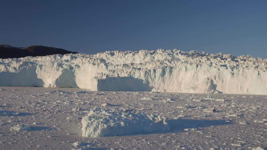 A large glacier near  a body of water
