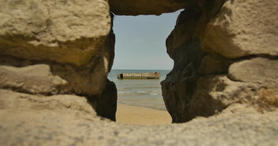 View between some rocks showing a beach